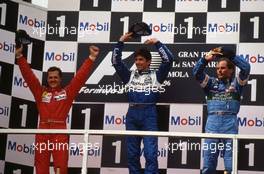 Michael Schumacher (GER) Ferrari 2nd position Damon Hill (GBR) Williams 1st position Gerhard Berger (AUT) Benetton 3rd position celebrates on podium