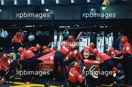 Michael Schumacher (GER) Ferrari F310 Scuderia Ferrari 3rd position during a pit stop