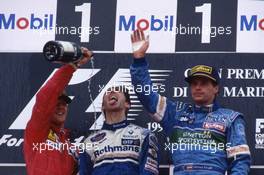 Michael Schumacher (GER) Ferrari 2nd position Damon Hill (GBR) Williams 1st position Gerhard Berger (AUT) Benetton 3rd position celebrate on podium with Champagne