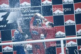 Michael Schumacher (GER) Ferrari 1st position celebrate podium with Jean Todt (FRA)