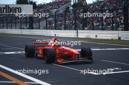 Michael Schumacher (GER) Ferrari F310B Scuderia Ferrari Marlboro 1st position takes victory