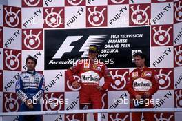 Heinz Harald Frentzen (GER) Williams 2nd position Michael Schumacher (GER) Ferrari 1st position Eddie Irvine (IRL) Ferrari 3rd position celebrate on podium