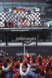 Heinz Harald Frentzen (GER) Williams 2nd position Michael Schumacher (GER) Ferrari 1st position Eddie Irvine (IRL) Ferrari 3rd position celebrate on podium