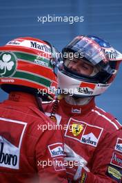 Michael Schumacher (GER) Scuderia Ferrari Marlboro 1st position celebrate victory with teammate Eddie Irvine (IRL) 3rd position