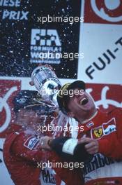 Michael Schumacher (GER) Scuderia Ferrari Marlboro 1st position celebrate on podium with teammate Eddie Irvine (IRL) 3rd position