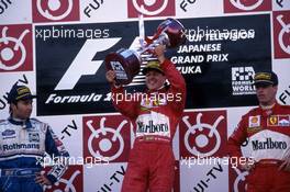 Heinz Harald Frentzen (GER) Williams 2nd position Michael Schumacher (GER) Ferrari 1st position Eddie Irvine (IRL) Ferrari 3rd position celebrate on podium
