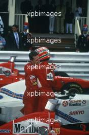 Michael Schumacher (GER) Ferrari 1st position celebrate victory with teammate Eddie Irvine (IRL) 3rd position