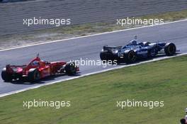 Jacques Villeneuve (CDN) Williams FW19 Renault Rothmans Williams Renault leads Michael Schumacher (GER) Ferrari F310B Scuderia Ferrari Marlboro 1st position