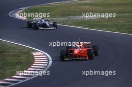 Michael Schumacher (GER) Ferrari F310B Scuderia Ferrari Marlboro 1st position leads Jacques Villeneuve (CDN) Williams FW19 Renault Rothmans Williams Renault