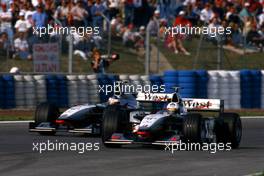David Coulthard (GBR) McLaren MP4/13 Mercedes 2nd position battles with teammate Mika Hakkinen (FIN) 1st position