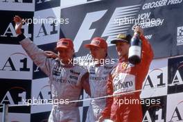 David Coulthard (GBR) McLaren Mercedes 2nd position Mika Hakkinen (FIN) McLaren Mercedes 1st position Michael Schumacher (GER) Ferrari celebrates podium