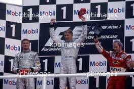 David Coulthard (GBR) McLaren Mercedes 2nd position Mika Hakkinen (FIN) McLaren Mercedes 1st position Jacques Villeneuve (CDN) Williams Mecachrome celebrates podium