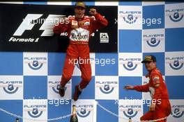 Michael Schumacher (GER) Ferrari 1st position Eddie Irvine (IRL) Ferrari 3rd position celebrate on podium