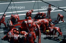 Michael Schumacher (GER) Ferrari F300 3rd position during a pit stop