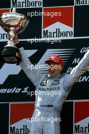 Mika Hakkinen (FIN) McLaren 1st position celebrate podium