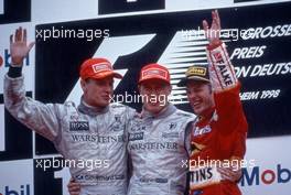 David Coulthard (GBR) McLaren Mercedes 2nd position Mika Hakkinen (FIN) McLaren Mercedes 1st position Jacques Villeneuve (CDN) Williams Mecachrome celebrates podium