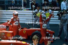 Michael Schumacher (GER) Ferrari 1st position and team-mate Eddie Irvine (IRL) 2nd position celebrate victory