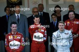 Eddie Irvine (IRL) Ferrari 2nd position Michael Schumacher (GER) Ferrari 1st position Mika Hakkinen (FIN) McLaren 3rd position celebrate podium