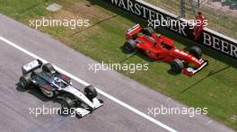 Formula One Championship 1999 - GP F1 Imola - Michae Schumacher (ger) Ferrari F399 team Ferrari F2008 watches rival Mika Hakkinen after dropping out of practice for the San Marino Grand Prix.