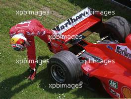 Formula One Championship 1999 - GP F1 Imola - Michae Schumacher (ger) Ferrari F399- Team Ferrari F2008 checks his car after dropping out of practice for the San Marino Grand Prix.