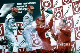 Mika Hakkinen (FIN) Mercedes 2nd position David Coulthard (GBR) Mercedes 3rd position Michael Schumacher (GER) Ferrari 1st position celebrate on podium with Jean Todt (FRA) Ferrari
