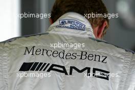 07.09.2003 Zeltweg, Österreich, Mercedes-Benz AMG logo on the back of the overal of Marcel Fässler (CHE), AMG-Mercedes - DTM 2003 in Zeltweg, Grand-Prix-Kurs des A1-Ring, Österreich (Deutsche Tourenwagen Masters)  - Weitere Bilder auf www.xpb.cc, eMail: info@xpb.cc - Belegexemplare senden.  c Copyright: Kennzeichnung mit: Miltenburg / xpb.cc