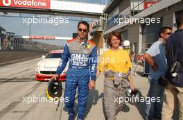 07.06.2003 Klettwitz, Deutschland, Alain Menu (CHE), OPC Team Holzer, Opel Astra V8 Coupé, walking in the pitlane with his wife after taking her for a ride with the Opel Astra V8 Coupé DTM taxi car - DTM 2003 in Klettwitz, EuroSpeedway Lausitz, Lausitzring (Deutsche Tourenwagen Masters)  - Weitere Bilder auf www.xpb.cc, eMail: info@xpb.cc - Belegexemplare senden. c Copyright: Kennzeichnung mit: Miltenburg / xpb.cc