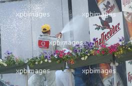 08.06.2003 Klettwitz, Deutschland, Podium, Bernd Schneider (GER), Vodafone AMG-Mercedes, spraying champaign on to the bobbo's behind the podium - DTM 2003 in Klettwitz, EuroSpeedway Lausitz, Lausitzring (Deutsche Tourenwagen Masters)  - Weitere Bilder auf www.xpb.cc, eMail: info@xpb.cc - Belegexemplare senden. c Copyright: Kennzeichnung mit: Miltenburg / xpb.cc