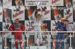 08.06.2003 Klettwitz, Deutschland, Podium, Bernd Schneider (GER), Vodafone AMG-Mercedes, Mercedes-Benz CLK-DTM (1st, center), Peter Dumbreck (GBR), OPC Team Phoenix, Opel Astra V8 Coupé (2nd, left), Mattias Ekström (SWE), PlayStation 2 Red Bull Abt-Audi, Abt-Audi TT-R (3rd, right), Hans-Jurgen Mattheis (GER), Team Manager HWA - DTM 2003 in Klettwitz, EuroSpeedway Lausitz, Lausitzring (Deutsche Tourenwagen Masters)  - Weitere Bilder auf www.xpb.cc, eMail: info@xpb.cc - Belegexemplare senden. c Copyright: Kennzeichnung mit: Miltenburg / xpb.cc