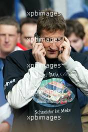 05.10.2003 Hockenheim, Deutschland, Bernd Schneider (GER), Vodafone AMG-Mercedes, Mercedes-Benz CLK-DTM, with 'Schneider ist Meister' T-Shirt receiving congratulations on the phone - DTM 2003 in Hockenheim, Grand-Prix-Kurs des Hockenheimring Baden-Württemberg (Deutsche Tourenwagen Masters)  - Weitere Bilder auf www.xpb.cc, eMail: info@xpb.cc - Belegexemplare senden.  c Copyright: Kennzeichnung mit: Miltenburg / xpb.cc