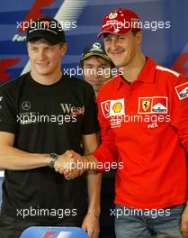 09.10.2003 Suzuka, Japan, F1 in Japan, Donnerstag, Press Conference, the two 2003 world championship title contenders Michael Schumacher (GER), Scuderia Ferrari Marlboro, Portrait (right) and Kimi Raikkonen (FIN), West McLaren Mercedes, Portrait (left) - Formel 1 Grand Prix von Japan 2003 (Suzuka Race Circuit) - Weitere Bilder auf www.xpb.cc, eMail: info@xpb.cc - Belegexemplare senden. Abdruck ist honorarpflichtig. c Copyrightnachweis: xpb.cc