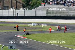 16.05.2004 Adria, Italy,  DTM, Sunday, Track marshalls removing the bumper of Bernd Schneider (GER), Vodafone AMG-Mercedes, AMG-Mercedes C-Klasse, and restoring the tyre barriers, after Schneider hit a tyre barrier in the chicane - DTM Season 2004 at Adria International Raceway (Deutsche Tourenwagen Masters, Italy)