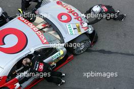 16.05.2004 Adria, Italy,  DTM, Sunday, Mercedes mechanics push the car of Bernd Schneider (GER), Vodafone AMG-Mercedes, AMG-Mercedes C-Klasse, into the pits after he hit one of the tyre barriers at the chicane - DTM Season 2004 at Adria International Raceway (Deutsche Tourenwagen Masters, Italy)