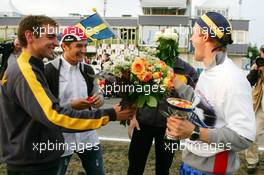 19.09.2004 Brno, Czech Republic,  DTM, Sunday, Opel drivers Jeroen Bleekemolen (NED), OPC Euroteam (left), Timo Scheider (GER), OPC Team Holzer (center), and Marcel Fässler (SUI), OPC Team Phoenix, come to congratulate Mattias Ekström (SWE), Audi Sport Team Abt, with his 2004 DTM championship - DTM Season 2004 at Automotodrom Brno, Czech Republic (Deutsche Tourenwagen Masters)