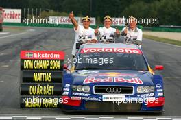 19.09.2004 Brno, Czech Republic,  DTM, Sunday, Audi group picture with new 2004 DTM champion Mattias Ekström (SWE), Audi Sport Team Abt, Audi A4 DTM (center), Hans-Jurgen Abt (GER), Teamchef Abt-Audi (left) and Dr. Wolfgang Ullrich (GER), Audi's Head of Sport (right) - DTM Season 2004 at Automotodrom Brno, Czech Republic (Deutsche Tourenwagen Masters)