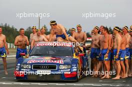 19.09.2004 Brno, Czech Republic,  DTM, Sunday, Audi group picture to celebrate the 2004 DTM championship of Mattias Ekström (SWE), Audi Sport Team Abt (center), with all team members including all drivers and team management, almost naked, just with shorts - DTM Season 2004 at Automotodrom Brno, Czech Republic (Deutsche Tourenwagen Masters)