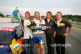 19.09.2004 Brno, Czech Republic,  DTM, Sunday, Opel drivers Timo Scheider (GER), OPC Team Holzer (left), Jeroen Bleekemolen (NED), OPC Euroteam (center), and Marcel Fässler (SUI), OPC Team Phoenix (right) come to congratulate Mattias Ekström (SWE), Audi Sport Team Abt, with his 2004 DTM championship - DTM Season 2004 at Automotodrom Brno, Czech Republic (Deutsche Tourenwagen Masters)