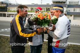 19.09.2004 Brno, Czech Republic,  DTM, Sunday, Opel drivers Jeroen Bleekemolen (NED), OPC Euroteam (left), Timo Scheider (GER), OPC Team Holzer (center) and Marcel Fässler (SUI), OPC Team Phoenix (right), come to congratulate Mattias Ekström (SWE), Audi Sport Team Abt, with his 2004 DTM championship - DTM Season 2004 at Automotodrom Brno, Czech Republic (Deutsche Tourenwagen Masters)