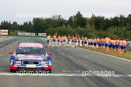 19.09.2004 Brno, Czech Republic,  DTM, Sunday, Audi group picture to celebrate the 2004 DTM championship of Mattias Ekström (SWE), Audi Sport Team Abt (center), with all team members including all drivers and team management, almost naked, just with shorts - DTM Season 2004 at Automotodrom Brno, Czech Republic (Deutsche Tourenwagen Masters)