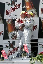 02.05.2004 Estoril, Portugal,  DTM, Sunday, Podium, Christijan Albers (NED), DaimlerChrysler Bank AMG-Mercedes, Portrait (1st, right) and Mattias Ekström (SWE), Audi Sport Team Abt, Portrait (2nd, right), discuss the overtaking manouvre on the podium - DTM Season 2004 at Circuito do Estoril (Deutsche Tourenwagen Masters, Portugal)