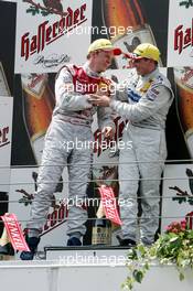 02.05.2004 Estoril, Portugal,  DTM, Sunday, Podium, Christijan Albers (NED), DaimlerChrysler Bank AMG-Mercedes, Portrait (1st, right) and Mattias Ekström (SWE), Audi Sport Team Abt, Portrait (2nd, right), discuss the overtaking manouvre on the podium - DTM Season 2004 at Circuito do Estoril (Deutsche Tourenwagen Masters, Portugal)