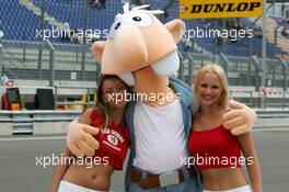 05.06.2004 Klettwitz, Germany,  DTM, Saturday, Girls having some fun with a comic doll - DTM Season 2004 at Lausitzring (Deutsche Tourenwagen Masters)