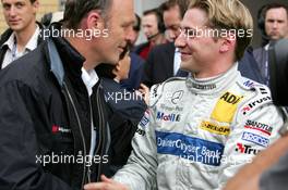 05.06.2004 Klettwitz, Germany,  DTM, Saturday, Dr. Wolfgang Ullrich (GER), Audi's Head of Sport (left), being very sportive and congratulates Christijan Albers (NED), DaimlerChrysler Bank AMG-Mercedes, Portrait (right), with his first pole position - DTM Season 2004 at Lausitzring (Deutsche Tourenwagen Masters)