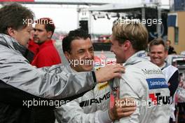 05.06.2004 Klettwitz, Germany,  DTM, Saturday, Norbert Haug (GER), Sporting Director Mercedes-Benz (left) and Jean Alesi (FRA), AMG-Mercedes, Portrait (center), congratulate Jean Alesi (FRA), AMG-Mercedes, Portrait (right) with his first pole position - DTM Season 2004 at Lausitzring (Deutsche Tourenwagen Masters)