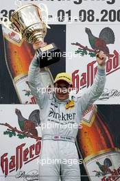 01.08.2004 Nürburg, Germany,  DTM, Sunday, Podium, Gary Paffett (GBR), C-Klasse AMG-Mercedes, Portrait (1st), holding up the winners trophy - DTM Season 2004 at Nürburgring (Deutsche Tourenwagen Masters)