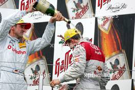 01.08.2004 Nürburg, Germany,  DTM, Sunday, Podium, Bernd Schneider (GER), Vodafone AMG-Mercedes, Portrait (3rd, left), giving Mattias Ekström (SWE), Audi Sport Team Abt, Portrait (2nd, right), a champaign shower - DTM Season 2004 at Nürburgring (Deutsche Tourenwagen Masters)