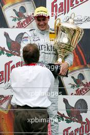 01.08.2004 Nürburg, Germany,  DTM, Sunday, Podium, Gary Paffett (GBR), C-Klasse AMG-Mercedes, Portrait (1st), receiving the winners trophy - DTM Season 2004 at Nürburgring (Deutsche Tourenwagen Masters)