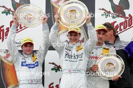 27.06.2004 Nürnberg, Germany,  DTM, Sunday, Podium, Gary Paffett (GBR), C-Klasse AMG-Mercedes, Portrait (1st, center), Christijan Albers (NED), DaimlerChrysler Bank AMG-Mercedes, Portrait (2nd, left), and Bernd Schneider (GER), Vodafone AMG-Mercedes, Portrait (3rd, right) - DTM Season 2004 at Norisring (Deutsche Tourenwagen Masters)