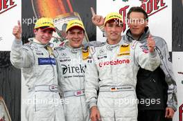 27.06.2004 Nürnberg, Germany,  DTM, Sunday, Podium, Gary Paffett (GBR), C-Klasse AMG-Mercedes, Portrait (1st, center), Christijan Albers (NED), DaimlerChrysler Bank AMG-Mercedes, Portrait (2nd, left) and Bernd Schneider (GER), Vodafone AMG-Mercedes, Portrait (3rd, right). Right: Hans-Jurgen Mattheis (GER), Team Manager HWA - DTM Season 2004 at Norisring (Deutsche Tourenwagen Masters)