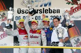 08.08.2004 Oschersleben, Germany,  DTM, Sunday, Podium, Tom Kristensen (DNK), Audi Sport Team Abt Sportsline, Portrait (1st, center), Martin Tomczyk (GER), Audi Sport Team Abt, Portrait (2nd, left) and Manuel Reuter (GER), OPC Team Holzer, Portrait (3rd, right). Far right: Hans-Jurgen Abt (GER), Teamchef Abt-Audi (winning constructor) - DTM Season 2004 at Motopark Oschersleben (Deutsche Tourenwagen Masters)